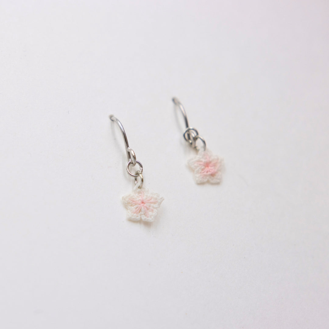 Pair of floral earrings on a white background