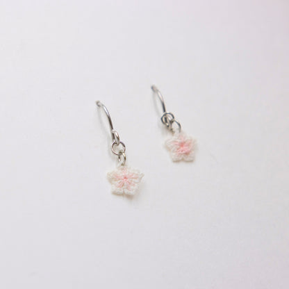 Pair of floral earrings on a white background
