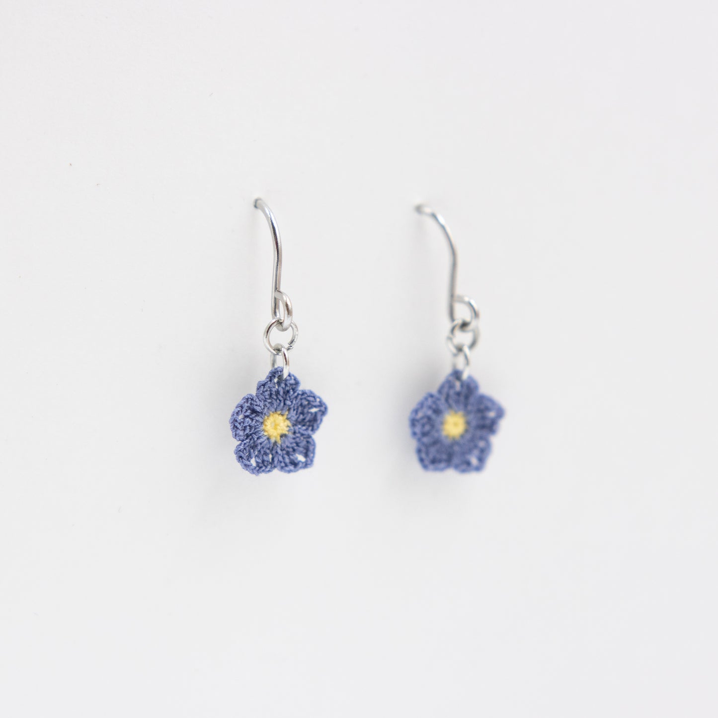 Flower-shaped earrings on a white background