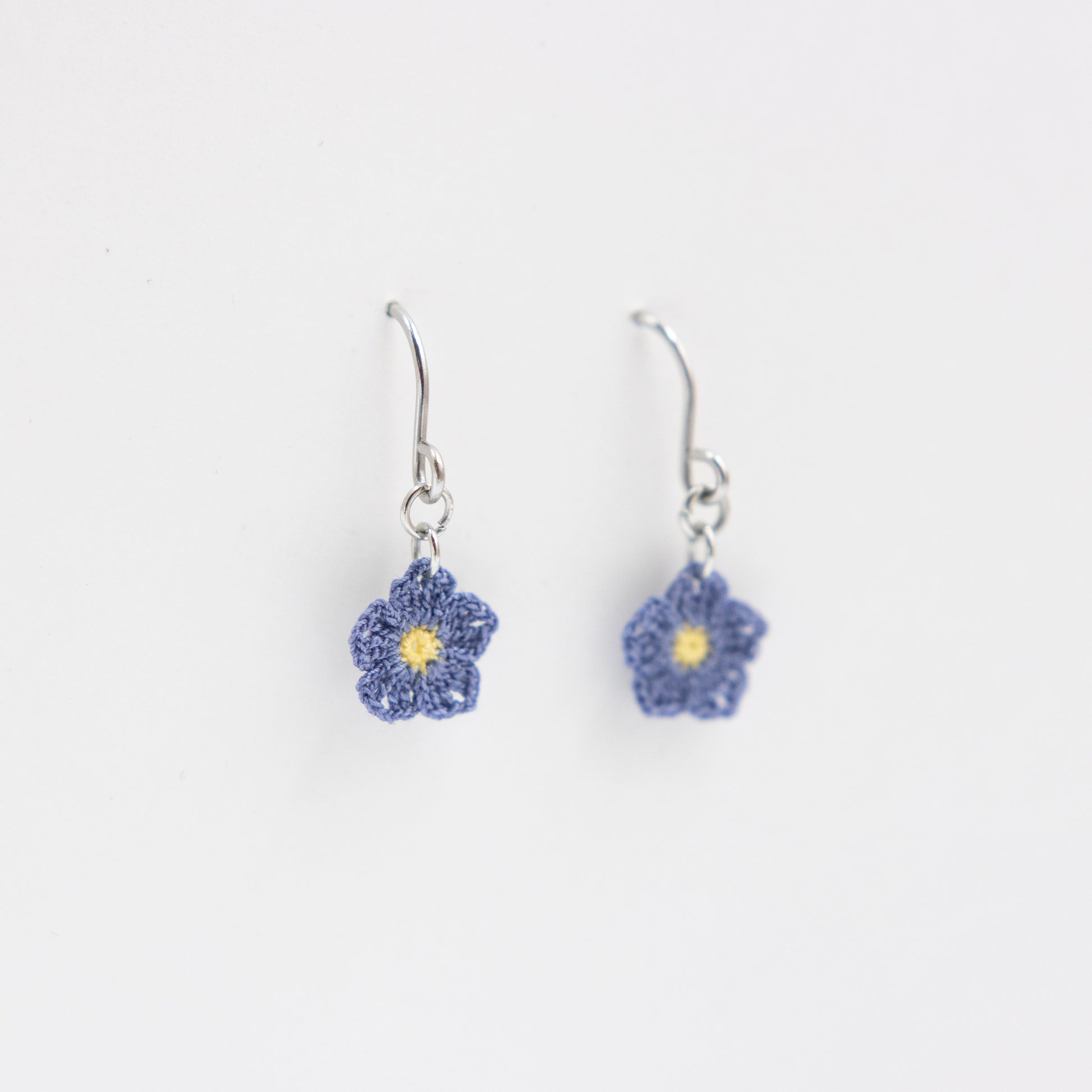 Flower-shaped earrings on a white background