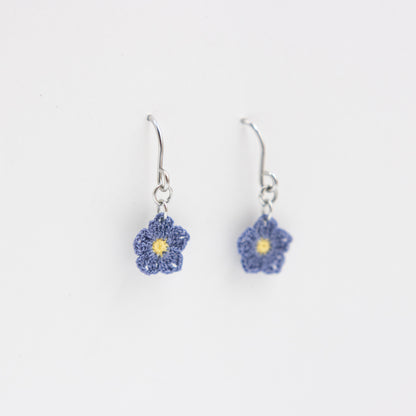 Flower-shaped earrings on a white background