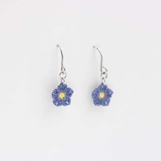 Flower-shaped earrings on a white background